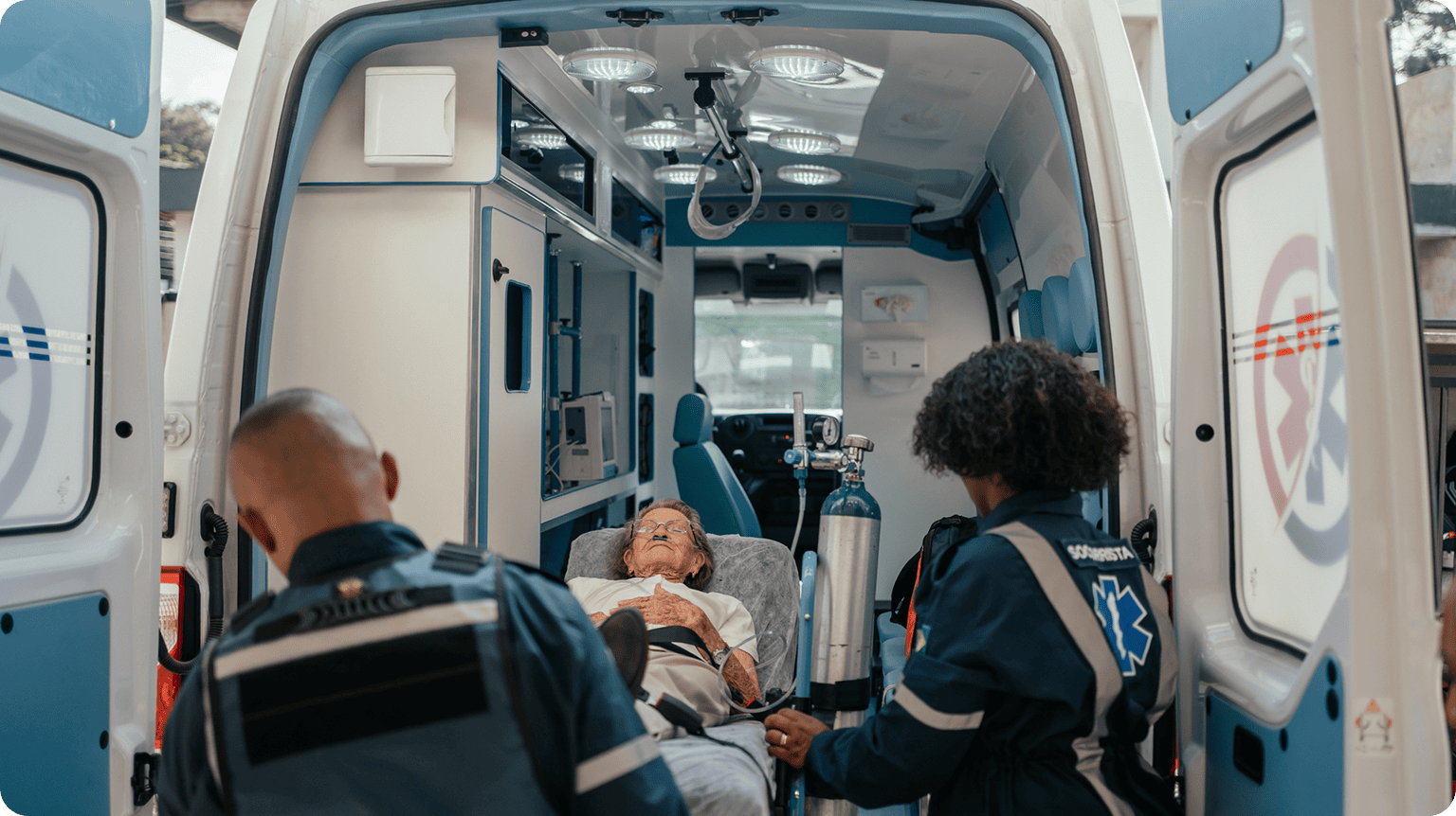 Two medics tending oxygen to elderly patient