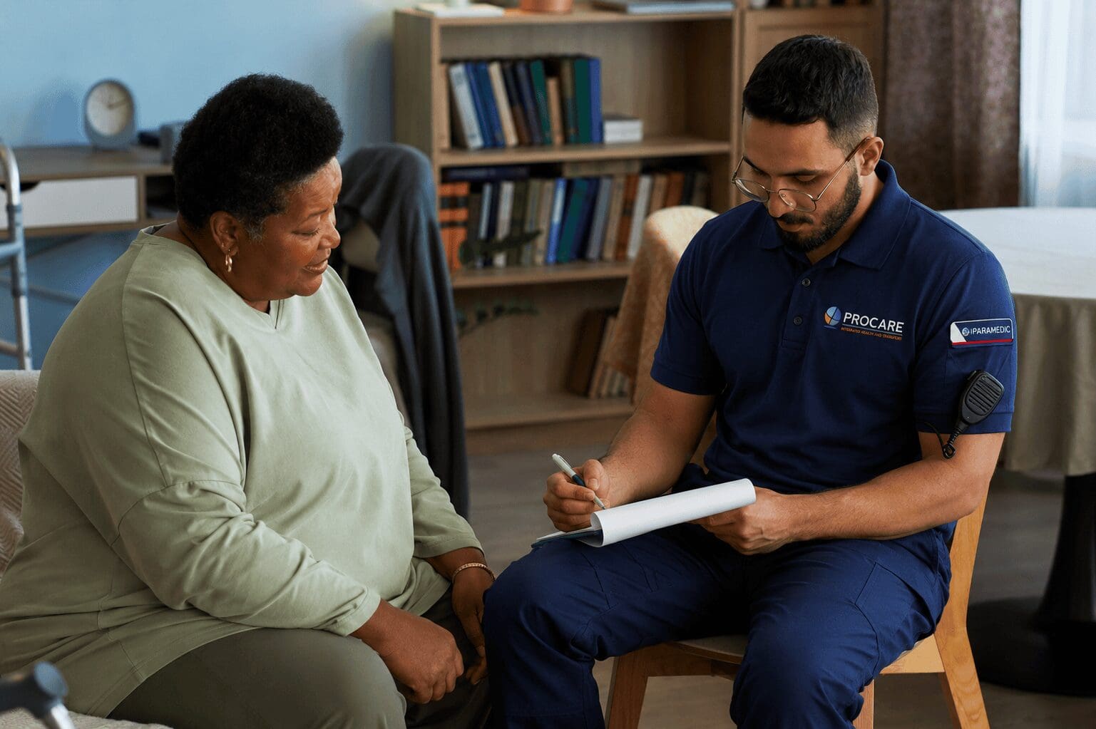 Paramedic taking notes while consulting patient