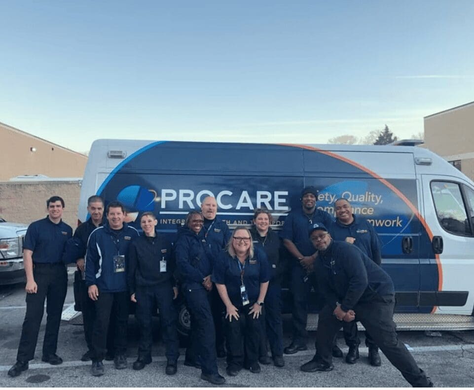Uniformed crew posing beside service van