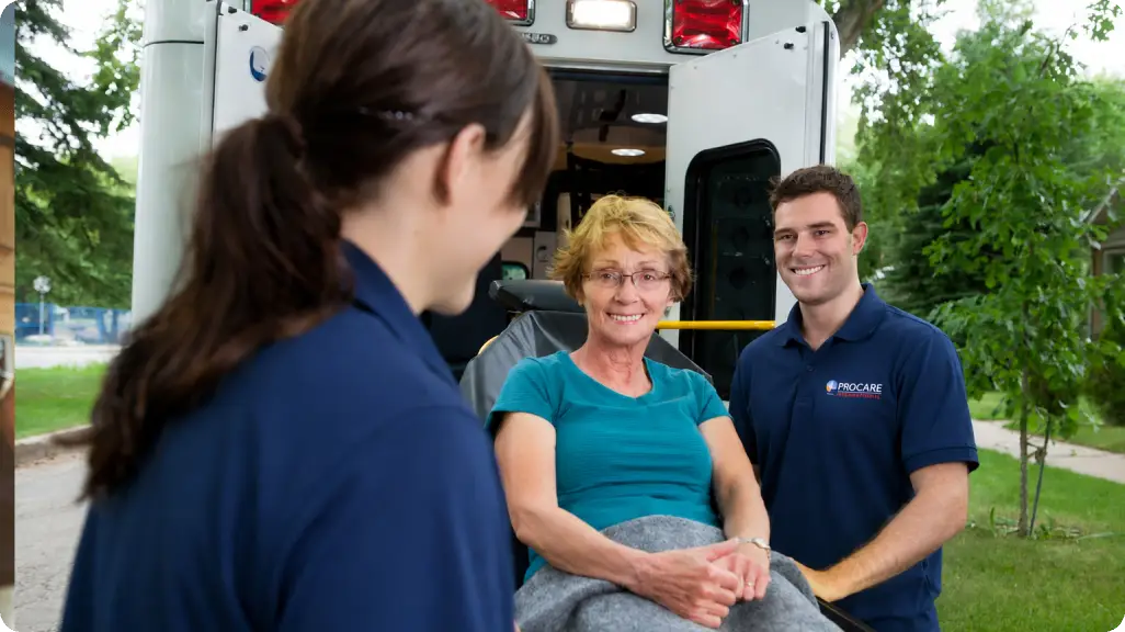 Care team smiling with seated patient