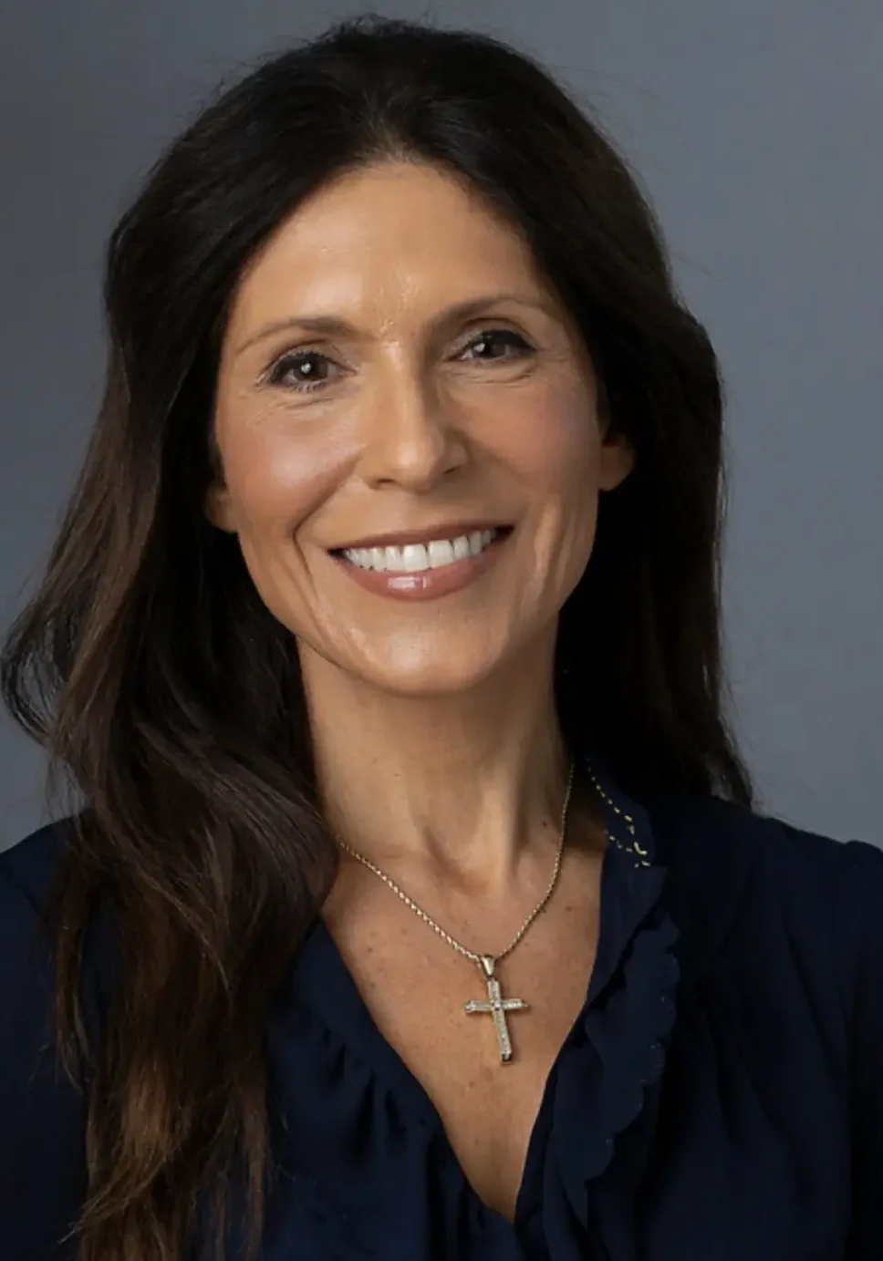 Smiling woman with cross necklace