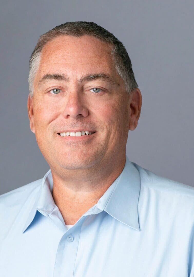 Blue-eyed man smiling in neutral portrait