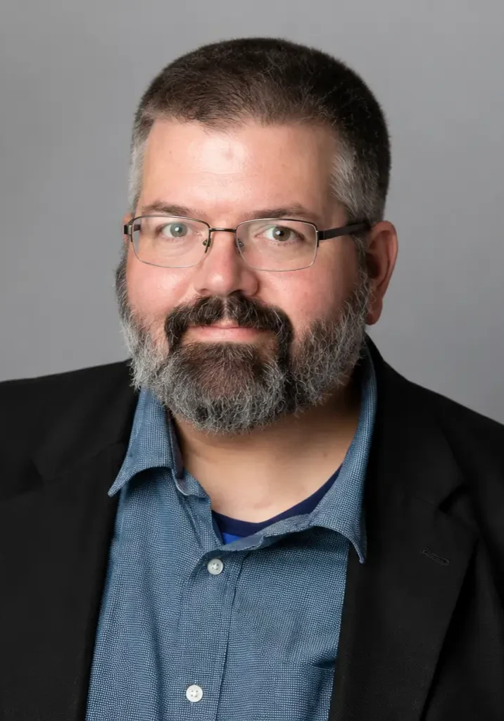 Professional headshot with gray background