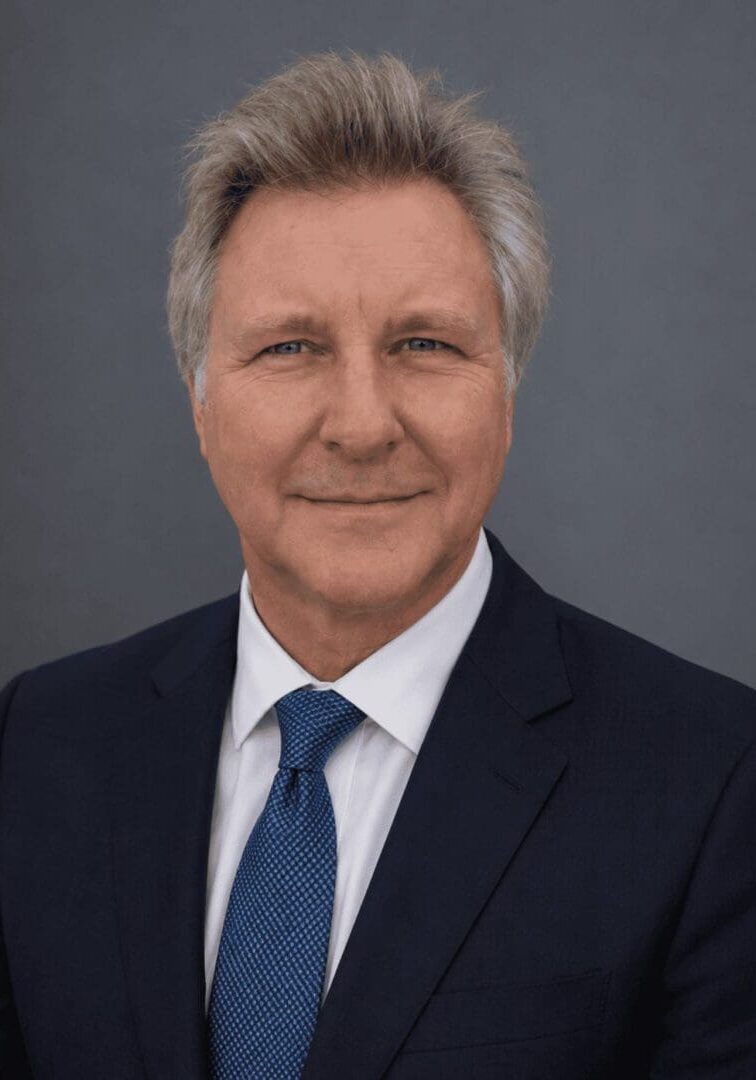 Professional headshot of a man in suit